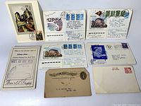 Single overview image showing eight mailed paper items: three postcards, four envelopes with stamps, one first day cover