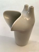 Front view of white dual-spout vase