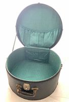 Hat box open showing green interior lining and pockets