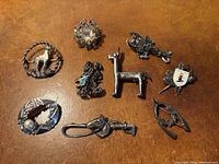 Group shot of nine brooches on surface