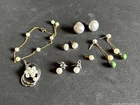All jewelry pieces laid out on black background