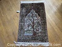 Full view of silk rug showing overall design and fringe