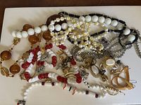 Group overview of all jewelry on white surface