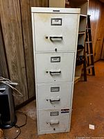 Full view of off-white four-drawer steel filing cabinet