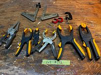 Full lot of assorted clamps arranged on workbench