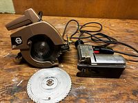 Black & Decker circular saw, Craftsman sabre saw, loose blade on bench