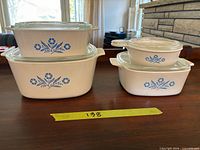 Group shot of four CorningWare casseroles with lids showing pattern and relative sizes