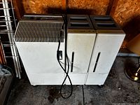 Front view of Bonaire dehumidifier showing reservoirs, vent grille, power cord