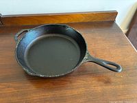 Top view of Lodge cast iron skillet showing cooking surface, handles and overall condition