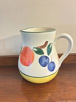 Front view showing peach and plums motif with handle