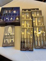 All boxed Fontignac flatware and serving sets on table