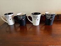 Four mugs on surface displaying exterior colors and design