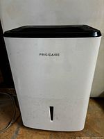 Front view of Frigidaire dehumidifier showing cabinet and water tank slot