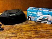 Panasonic iron box and Sony boombox on table