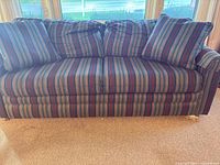 Front view of La-Z-Boy striped 3-seat sofa with two cushions