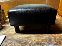 Overall view of footstool front and top surface