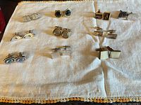 Overview of 10 cufflink pairs on cloth