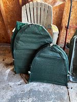 two shrub covers leaning against plastic chair