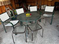 Patio set showing round table, four chairs, three side tables