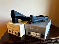 Both shoe pairs on respective Rockport boxes