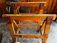 Top view of both wooden sawhorses showing metal reinforcement plates