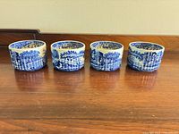 Four blue and white Spode ramekins side by side