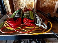 All cords coiled on shelf; packaged red cords, yellow, grey and black cords visible