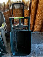 Rubbermaid green plastic yard cart tub with handle visible