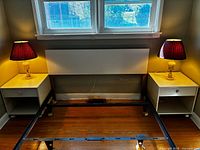 Headboard, metal frame, two nightstands under window
