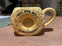 Front of mug showing bagel shape and printed text