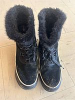Top view of both boots showing fur collar, laces, wear on toe area
