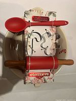Top view of packaged set showing spoon, rolling pin, cookie cutters on bowl