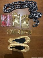 All items laid flat showing chain, gloves, belt, flats, packaged sunglasses