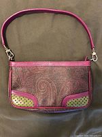 Front view of Etro paisley purse with pink leather trim and lime perforated corners
