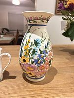 Front of hand-painted Greek vase showing floral design