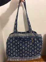Front view of blue quilted paisley tote