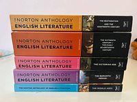 Stack of five Norton Anthology volumes showing spines and titles