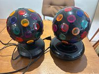 Both disco ball lights side by side on table