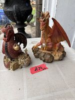 Both dragon figurines side by side