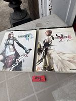 Both Final Fantasy XIII series guide books front covers