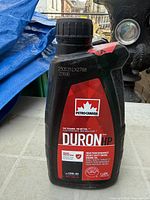 Front view Petro-Canada Duron HP 1 L bottle showing label and sealed cap