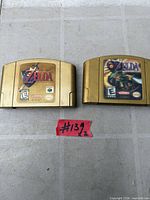 Both Nintendo 64 gold game cartridges side by side