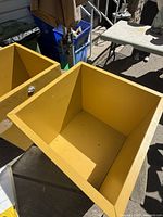 Two yellow wood storage bins showing interiors and color