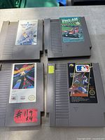 Four NES cartridges laid out showing game titles and label condition