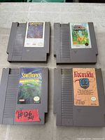 Top and bottom view of four NES cartridges: Gauntlet, Wizards & Warriors, StarTropics, Faxanadu