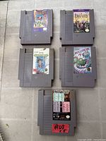 Five NES cartridges laid out showing labels