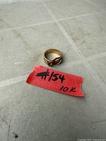 10K gold snake ring with label indicating karat