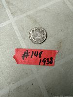 Reverse side showing Canadian coat of arms and 50 CENTS CANADA 1938 legend