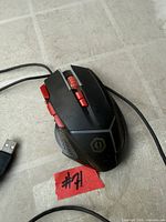 Top view of black and red wired gaming mouse showing buttons, scroll wheel and logo