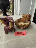 Both dragon figurines side by side on table